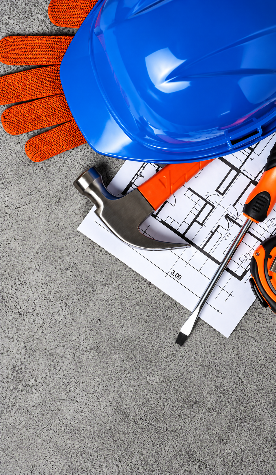 Safety helmet, gloves and tools on a site plan